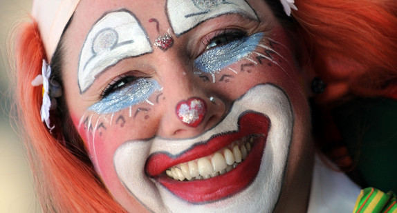 Ein Clown der Narrenzunft Rottenburg läuft beim großen Umzug des Weißnarrentreffens in Villingen-Schwenningen durch die Innenstadt (Quelle: dpa).