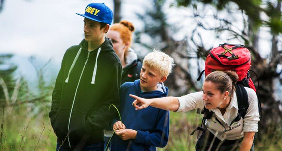 Eine Rangerin führt eine Gruppe Kinder durch den Nationalpark Schwarzwald. (Bild: © qu-int.gmbh / Nationalpark Schwarzwald)