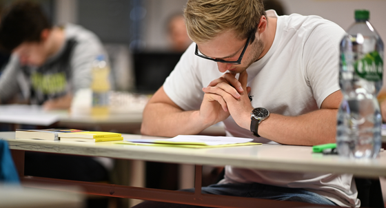 Abiturienten lesen sich kurz vor Beginn der Prüfung die Abituraufgaben im Fach Deutsch durch. (Foto: © picture alliance/Felix Kästle/dpa)