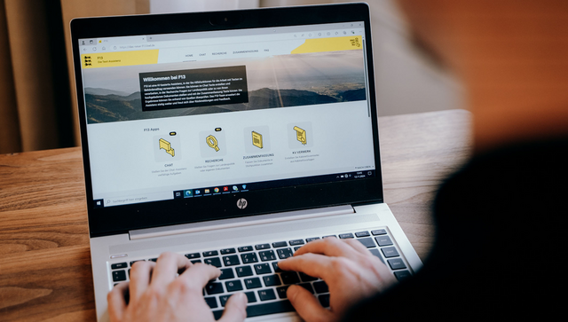 Eine Person arbeitet an einem Laptop mit der KI-basierten Text-Assistenz F13.